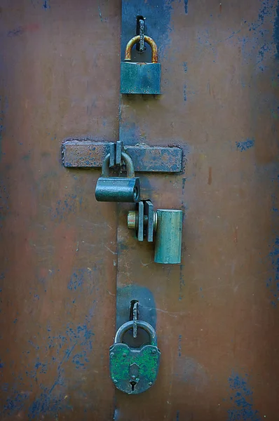 Many locks and bolts on the gate.