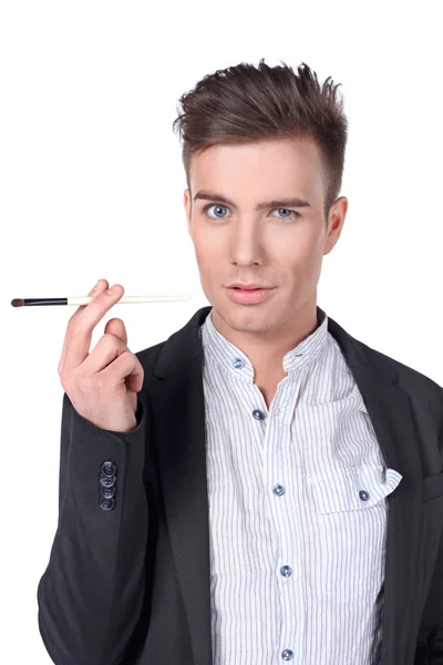 Stylish young handsome man in a suit with a brush. — Stock Photo, Image