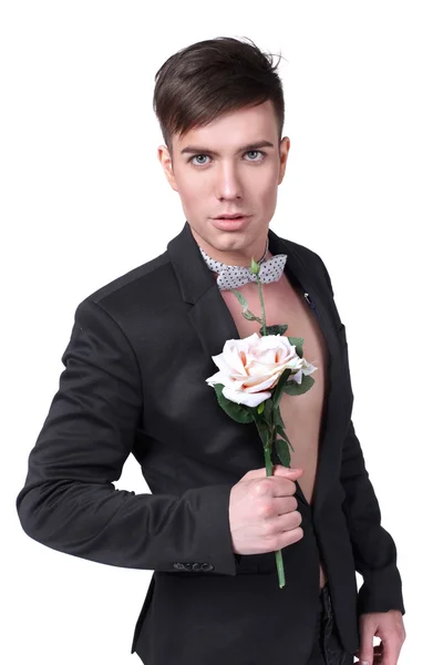 Mladý pohledný stylový muž v saku s květinou — Stock fotografie