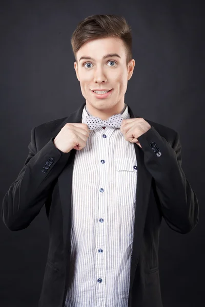 Young attractive man in a jacket and bow tie — Stock Photo, Image