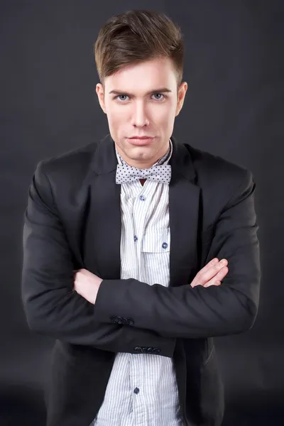 Young attractive man in a jacket and bow tie — Stock Photo, Image