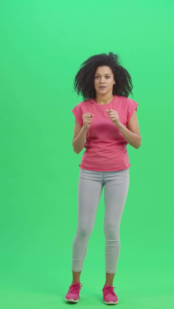 Portrait of young female African American looking at camera with excitement and anticipation, then very upset. Black woman on green screen. Slow motion ready 59.97fps. Vertical video. Full length. — Stock Video
