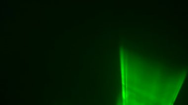 Siyah dumanlı arka planda konser sırasında parlak yeşil neon ışıklar yanıp sönüyor. Lazer ışıkları dumanla hareket eder. Profesyonel renkli ışıklandırma ve parti için ışık gösterisi efektleri. Kapat..