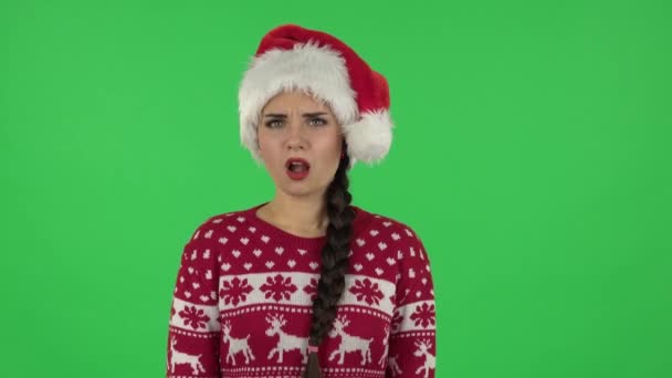 Portrait of sweety girl in Santa Claus hat angrily pointing herself, saying who me no thanks i do not need. Green screen — Stock Video