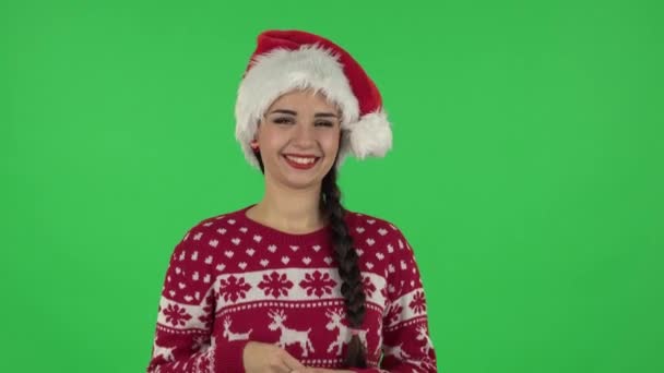 Portrait of sweety girl in Santa Claus hat in anticipation of worries, then smiling and proud of himself. Green screen — Stock Video