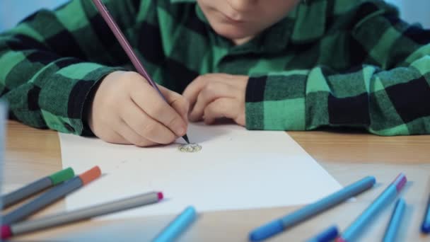 Little schoolboy sitting at table in room, drawing with pencil and wipe with an eraser in album. A teenager boy is engaged in creativity, draws a picture. Close up. Slow motion ready, 4K at 59.94fps. — Stock Video