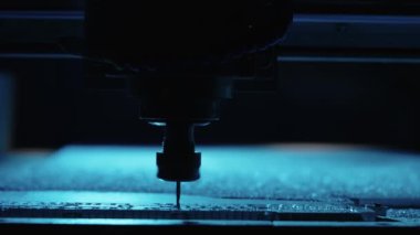 Metal fabrikası. Sondaj çeliği, yavaş çekim. Sondaj makinesi metali işliyor, şekli kesiyor. Detayların modern işleme teknolojisi. Endüstriyel detayları mavi ışıkta kapatıyoruz.