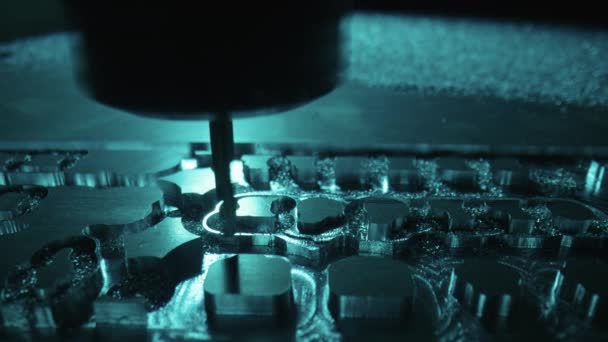 Metalworking milling machine. Drilling steel, slow motion. Drilling machine processes metal, cuts out shape. Modern processing technology of detail. Making industrial details close up in blue light. — Stock Video