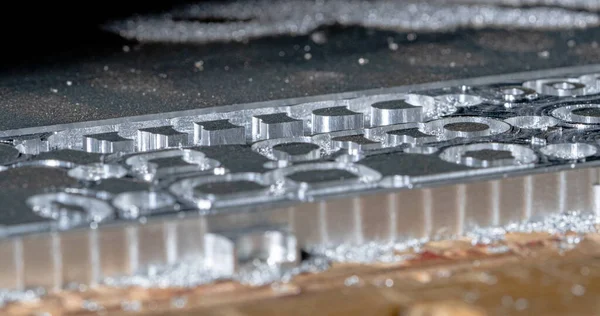 Fresadora CNC de metalurgia. Perforación de acero. Una máquina de perforación procesa metal, corta una forma. Moderna tecnología de procesamiento de detalles. Acercamiento de los detalles industriales. — Foto de Stock