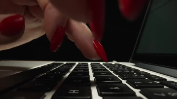 Macro dolly a filmé des images coulissantes de femmes tapant sur un clavier d'ordinateur portable dans un bureau sombre. Doigts féminins toucher ordinateur portable clavier. Travail indépendant, éducation en ligne. Ferme là. Mouvement lent. — Video