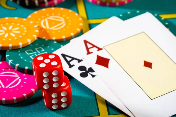Casino chips with dice and playing cards on game table. Concept of gambling or poker and entertainment. Two aces on the poker table for gambling and betting. Close up macro shoot. — Stock Photo, Image
