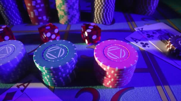 Câmera panelas sobre uma mesa de jogo com cartões, pilhas de chips, dados e um chip de revendedor. Feche-se de um jogo de pôquer em um cassino na luz azul. O conceito de jogo, apostas no casino. — Vídeo de Stock