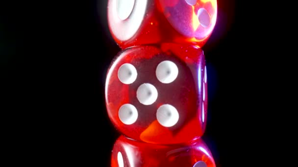 Red dice spinning on an isolated black background. Red cube, craps close up. Gambling background. The concept of playing poker, entertainment. Online casino on the Internet. — стоковое видео