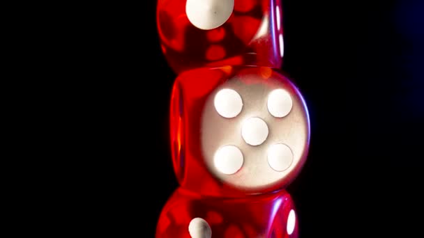 Red dice spinning on an isolated black background. Red cube, craps close up. Gambling background. The concept of playing poker, entertainment. Online casino on the Internet. — Stock Video