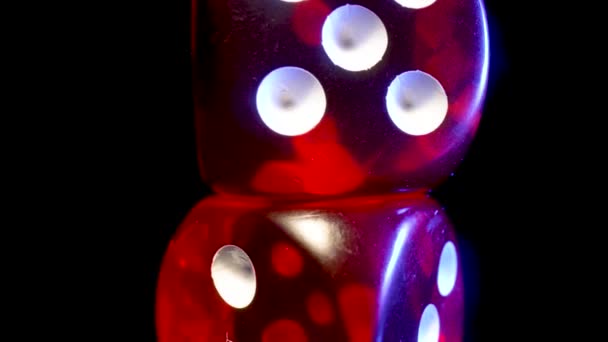 Red dice spinning on an isolated black background. Red cube, craps close up. Gambling background. The concept of playing poker, entertainment. Online casino on the Internet. — Vídeos de Stock