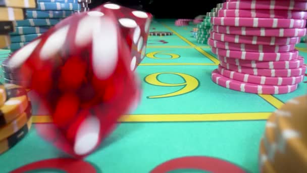 Camera pans over green gaming table with stacks of casino chips on a black background. Red dice thrown on the table fly straight into camera. Craps. Concept of betting. Close up in slow motion. — Stock Video