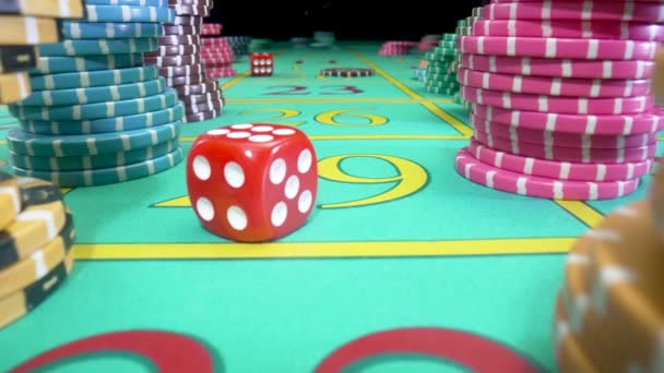 Camera pans over green gaming table with stacks of casino chips on a black background. Red dice thrown on the table fly straight into camera. Craps. Concept of betting. Close up in slow motion. — Vídeos de Stock