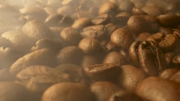 Freshly roasted brown coffee beans close up. Smoke comes from coffee beans. Fragrant coffee grain are roasted. Preparation of coffee seeds for cafe or cafeteria. Slow motion ready 59.94fps. — Video Stock