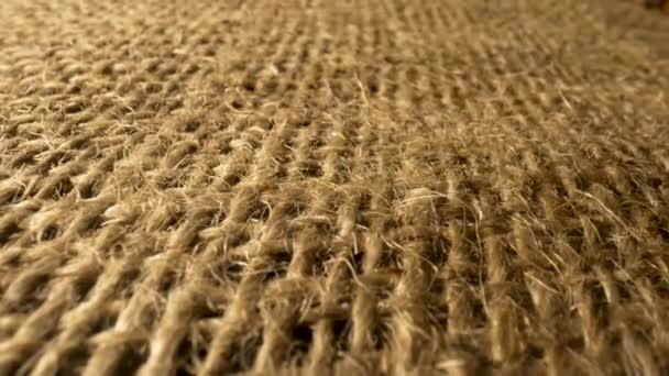 Textured linen or cotton burlap with binding brown fibres. Rough burlap sack texture. Weave woven sackcloth with natural fiber close up. Macro. Rustic vintage view. Slow motion ready 59.94fps. — Videoclip de stoc