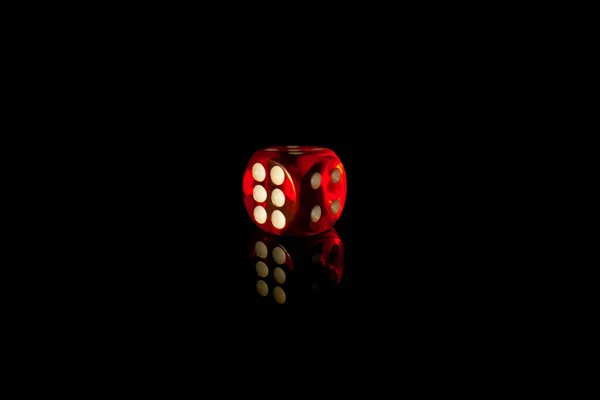 Red square dice on a black isolated background. Dice for playing craps or poker close up. Translucent dice with numbers. Gambling in the casino. Online casino over the internet. — Stock Photo, Image