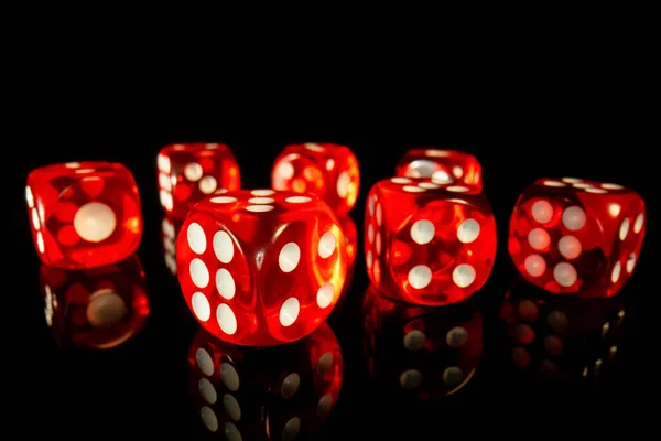 A set of red square dice on a black isolated background. Dice for playing craps or poker close up. Translucent dice with numbers. Gambling in the casino. Concept of playing poker, entertainment. — Zdjęcie stockowe