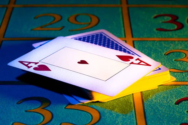 Ace of hearts in playing deck of cards. Playing cards close-up on gaming table in the casino. Stack pasteboard for playing poker or blackjack. The concept of gambling, entertainment, betting, risk. — Stock Photo, Image