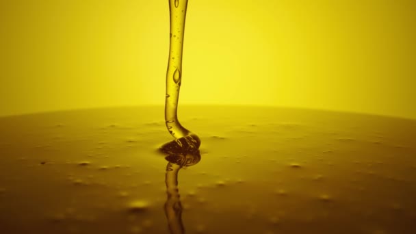 Honey dripping, pouring thick stream on yellow background. Viscous honey molasses flowing. Close up of golden honey liquid, sweet product of beekeeping. Sugar syrup is pouring flow. — Vídeo de Stock