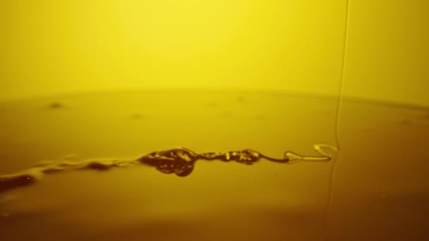 Honey dripping, pouring thick stream on yellow background. Viscous honey molasses flowing. Close up of golden honey liquid, sweet product of beekeeping. Sugar syrup is pouring flow. — Stock videók