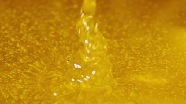 Honey dripping, pouring from spoon. Thick viscous honey molasses dripping. Close up of golden honey liquid, sweet product of beekeeping. Sugar syrup is pouring. Healthy and curative dessert. — стоковое видео