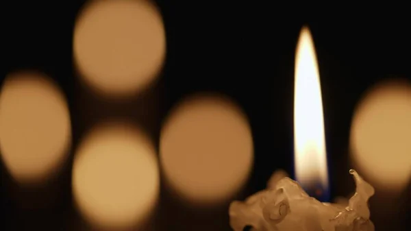 Wax Burning Candle Flickers Dark Black Background Blurred Candlelight Bokeh — Stock Photo, Image