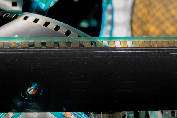 Black strips of old analog film with scratches and scuffs. Photo or video film for films or pictures close up. The concept of retro cinematography, photography, photographic memories. Media art