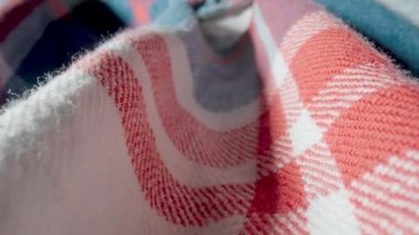 Makro renkte sıcak yün ekose gömlek. Giysinin yapısı, tekstil malzemesi, yün ya da pamuktan yapılmış yumuşak kumaş. Beyaz, mavi, kırmızı kareli kumaş. Giysi dokusu yakın. Moda.