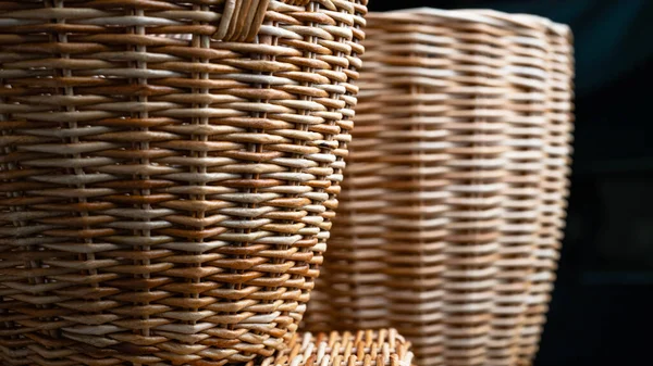 Handmade basket made of brown paper tubes. Texture of a braided pattern from eco vines. Basket weaving background, striped binding. Creativity, art, handwork, hobby. Weaving and knitting design from