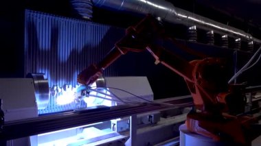 Automatic industrial robotic welding machine that applies coatings to metal by thermal spraying. Flame spraying of powder on outside rotating steel detail in metallurgical plant. Plasma welding with