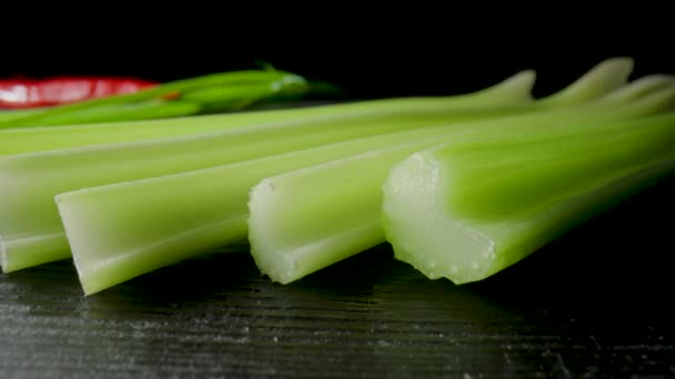 Row Green Celery Stalks Lying Black Board Isolated Black Studio — Stok video