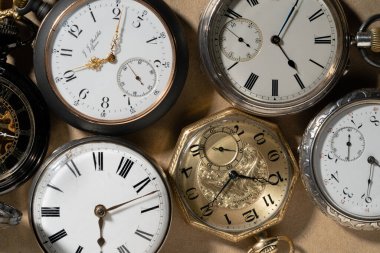 A set of antique gold and silver American and Swiss pocket watches with markings. Retro mechanical watch with white dials, hands and numbers. Presentation of old vintage round pocket watch for