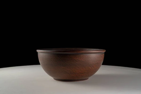 Empty Earthen Deep Bowl White Table Isolated Black Studio Background — 图库照片