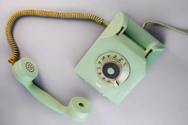 Old Green Antique Rotary Telephone Removed Receiver Blue Background Vintage stockbilde