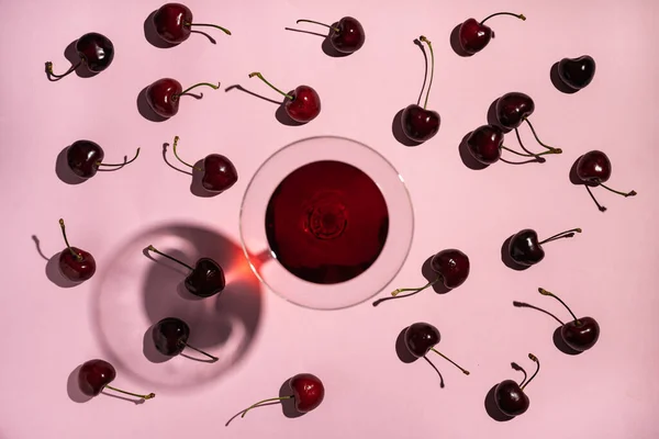 Ripe Red Sweet Cherries Tails Scattered Pink Background Next Wineglass — Stock Photo, Image