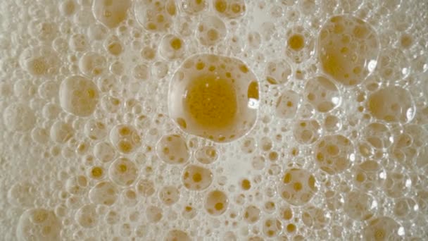 Top View Golden Liquid White Foam Bursting Bubbles Macro Shot — Stockvideo