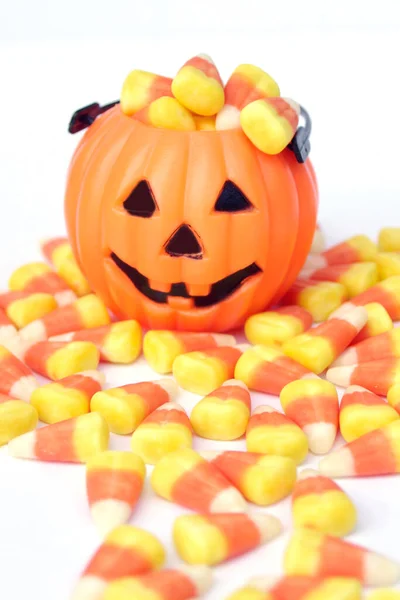 orange pumpkin bag with Halloween candy corn with mini Jack-o-lantern pumpkin