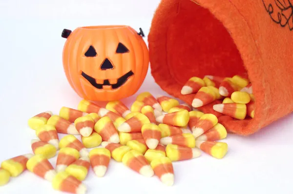 orange pumpkin bag with Halloween candy corn with mini Jack-o-lantern pumpkin