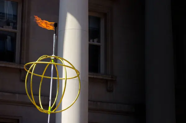 golden globe with fire baton on dark street background