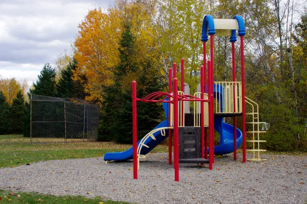empty playground equipment in park in fall