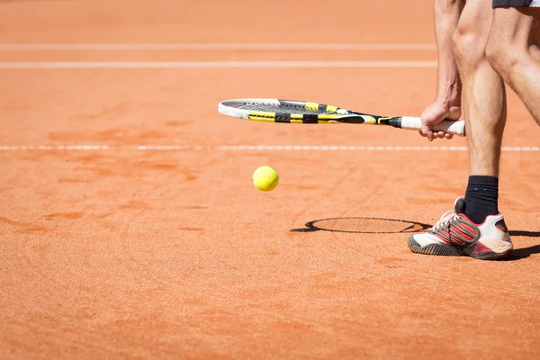 Sportsman catchs up his tennis ball with racket — Stock Photo, Image