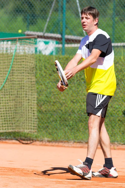 Male tennis player before serving ball