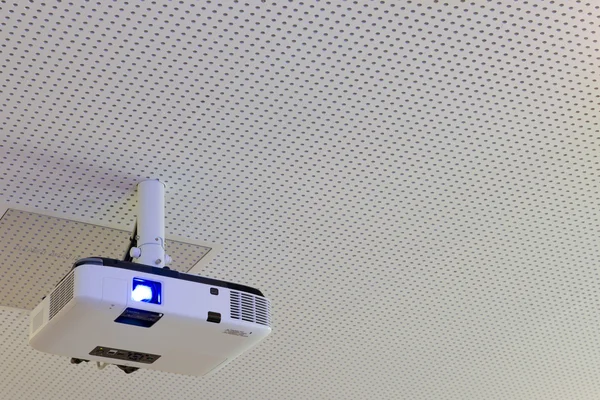 Turned on lcd video projector with ceiling suspension — Stock Photo, Image