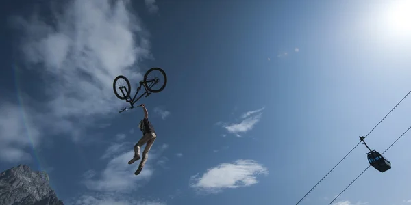 Young dirt biker looses control over his bicycle while his stunt high in the ai