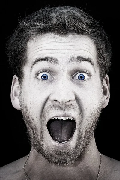 Portrait of a young blue eyed men with three-day beard, who's shouting out loud. — Stock Photo, Image