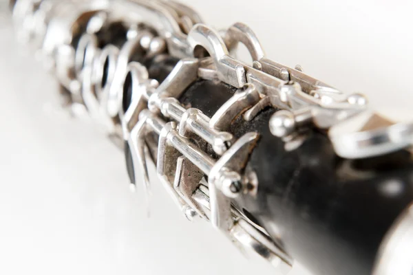 Black music clarinet decorated with silver metal on white background — Stock Photo, Image